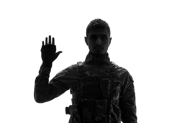 Soldier silhouette serious handsome strong tough army soldier in uniform saying hello