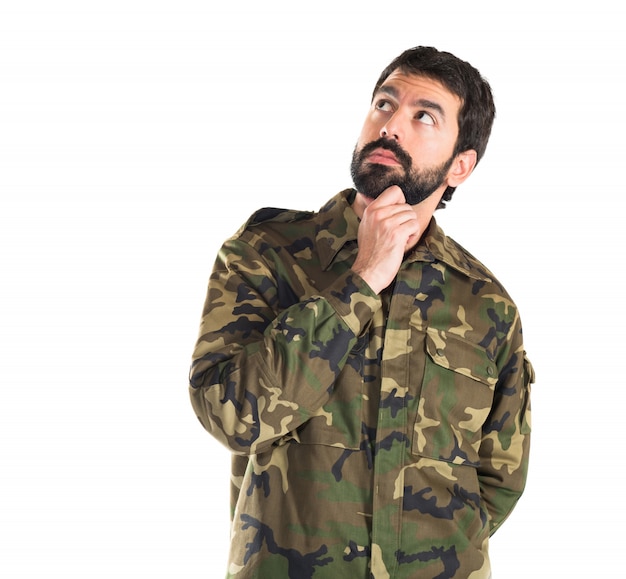 Soldier thinking over white background