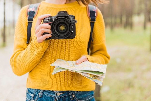 Free photo solo traveling woman holding camera