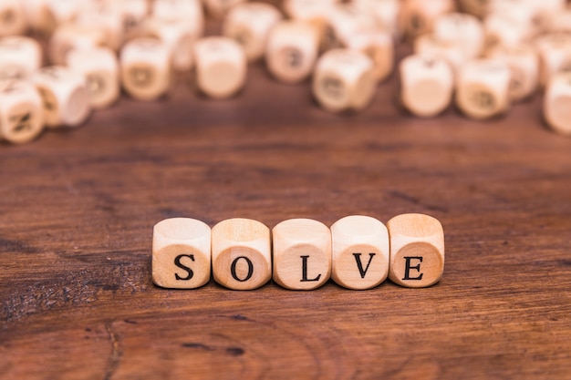 Free photo solve word on wooden cubes over brown table