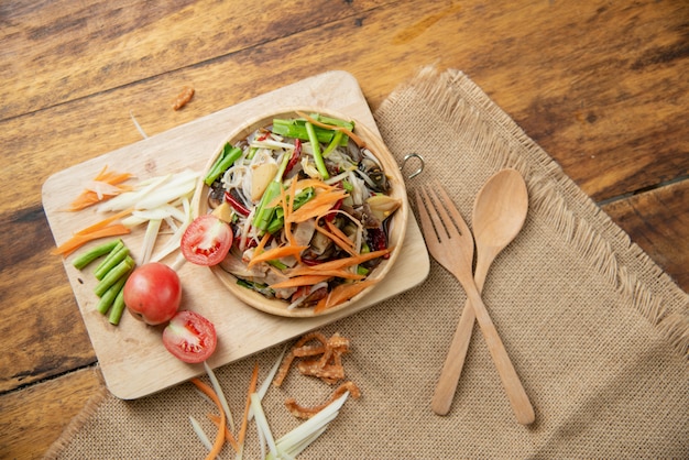 Som Tam Thai, Thai Papaya Salad on wooden background