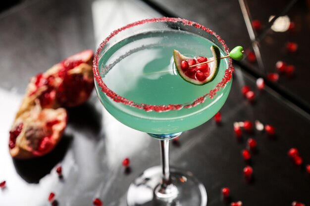 Some beverage with pomegranate and syrup on top close-up view