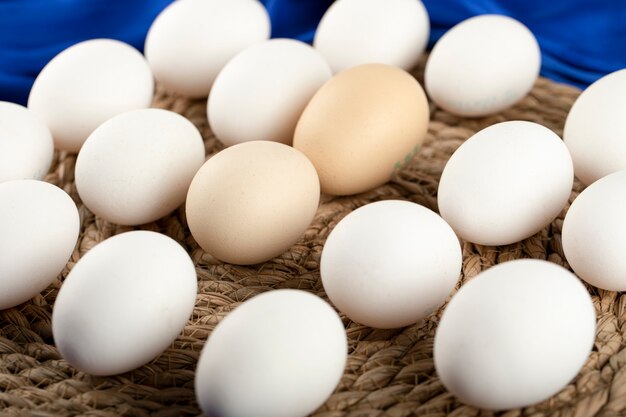 Some of brown and white raw chicken eggs . 