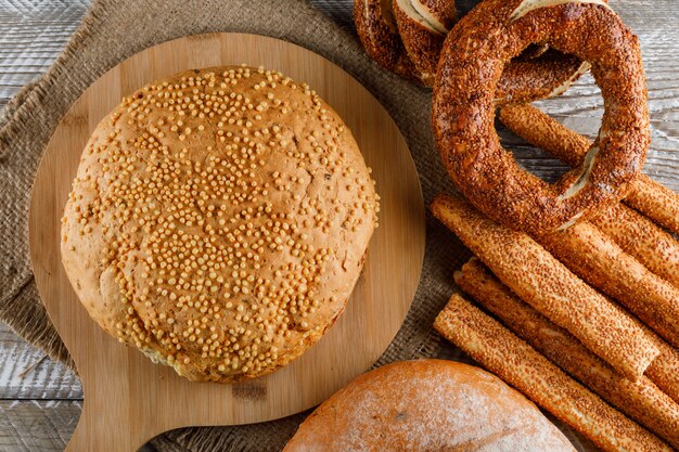 Some cake with turkish bagel in a cutting board on wooden surface, top view.