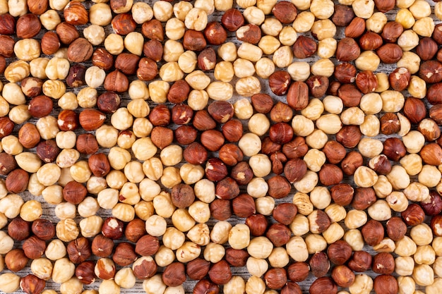 Free photo some of cleaned hazelnuts on white wooden table, flat lay.