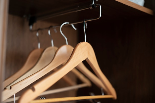 A some empty wooden hangers inside the home vintage wardrobe