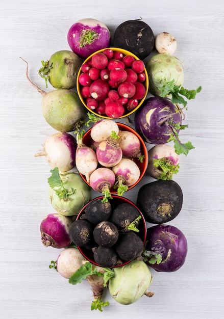 Free photo some of fresh different color radishes in a different color bowls