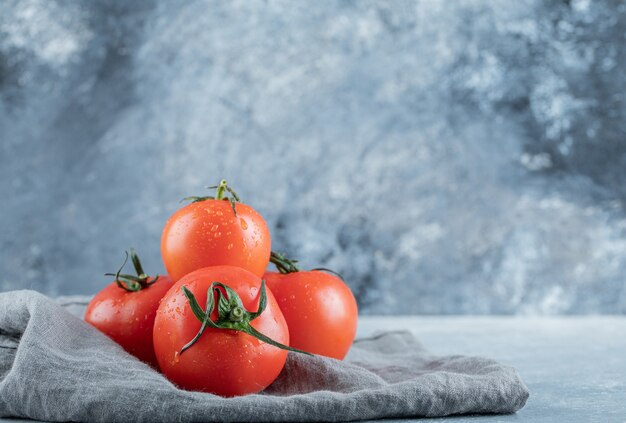 灰色のテーブルクロスにフレッシュトマトのいくつか。