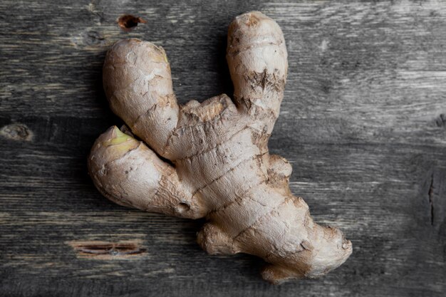 Some ginger on dark wooden background, close-up.