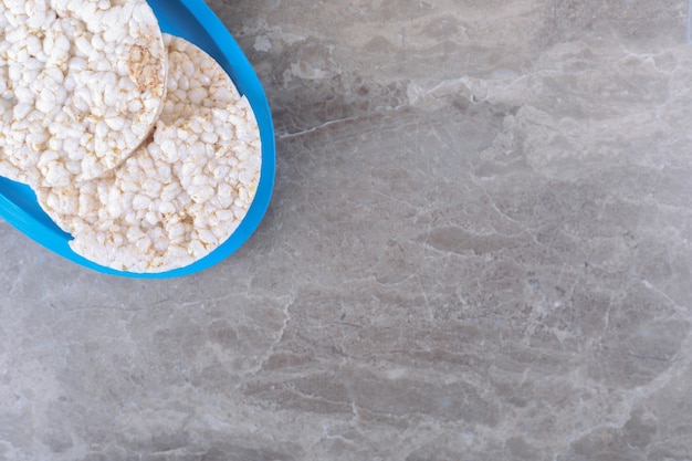 Some rice cakes on the board, on the marble surface