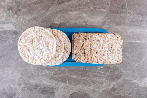 Some rice cakes on the board, on the marble surface