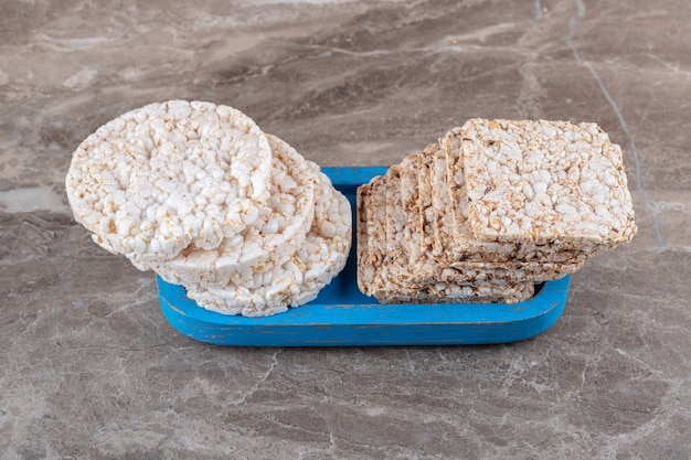 Some rice cakes on the board, on the marble surface