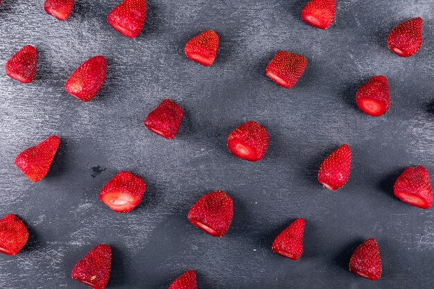 Some strawberries on dark table, pattern composition