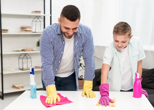 Free photo son and father cleaning together