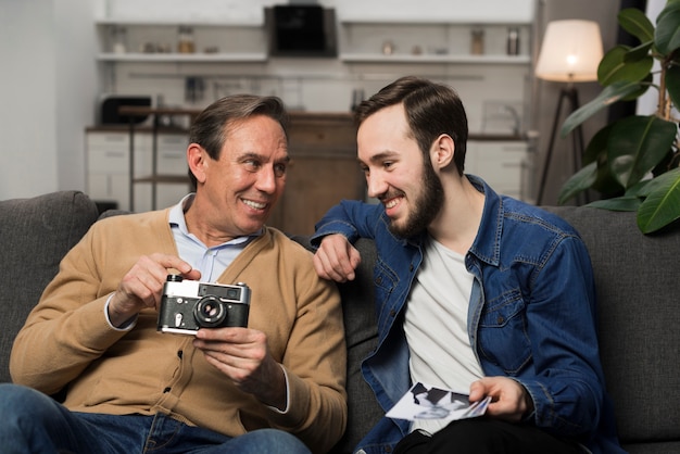 Son and father looking at pictures