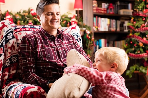 Son and father playing on christmas