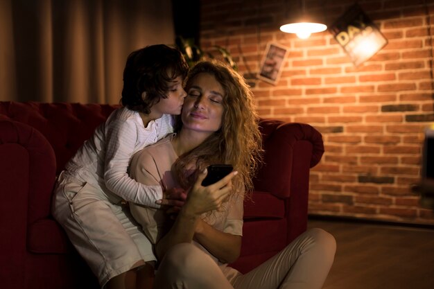 Son kissing his mother on the cheek