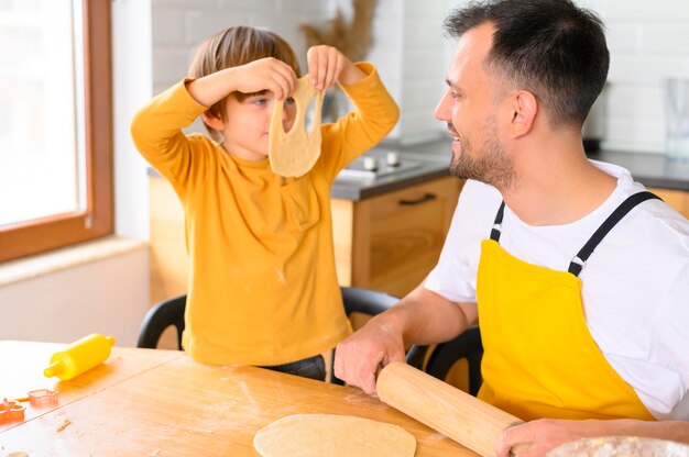 Son puts a dough mask on his face