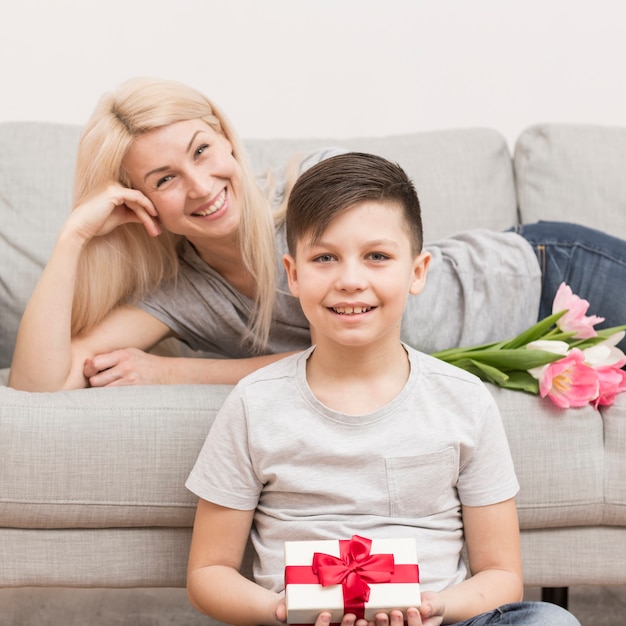 Free photo son surprising mother on mothers day