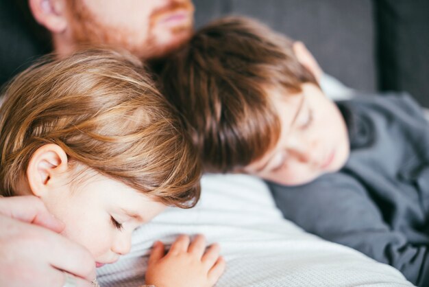 Sons sleeping on father chest 