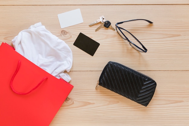 Sopping bag and woman's accessories on wooden desk