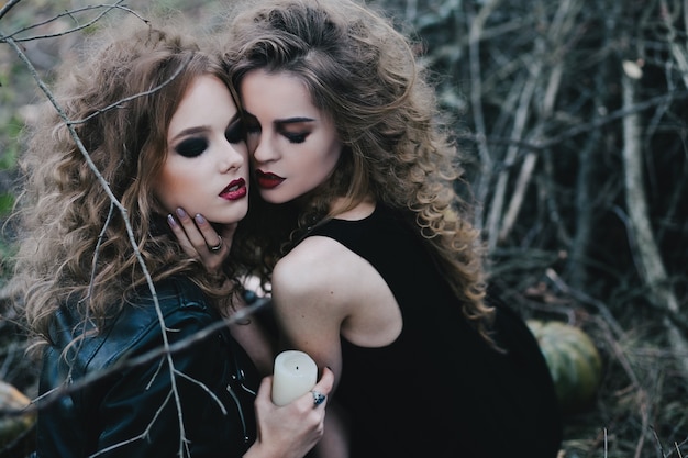 Sorceresses holding a white candle