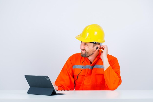 Sorry engineer is looking away by scratching his neck on white background