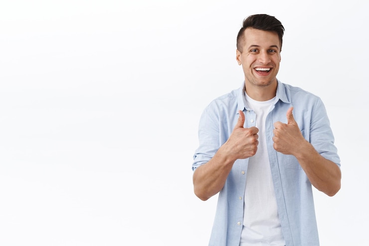 Free Photo sounds interesting good idea nice job friend portrait of handsome caucasian adult man recommend item or product best delivery service show thumbup and smiling in approval white background