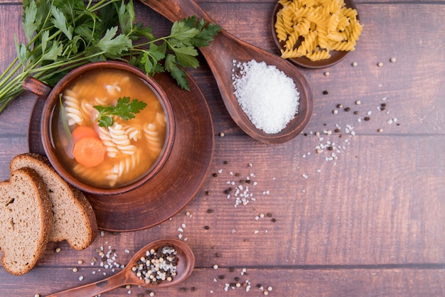 Soup in bowl with bread and copy space