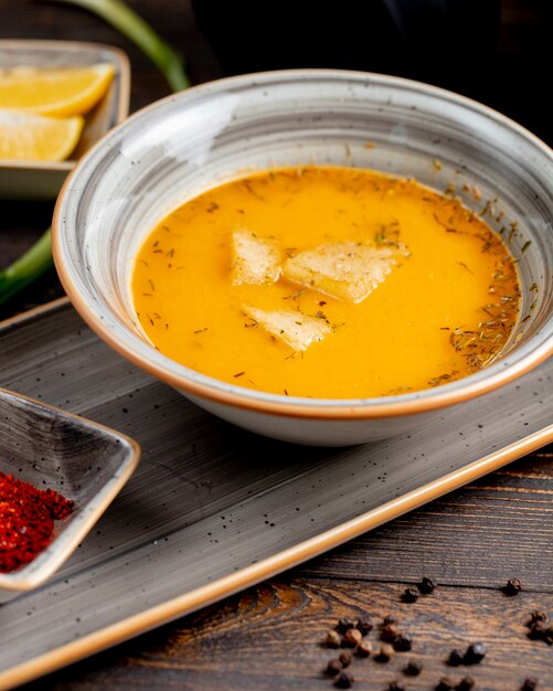 Soup served with herbs and crackers