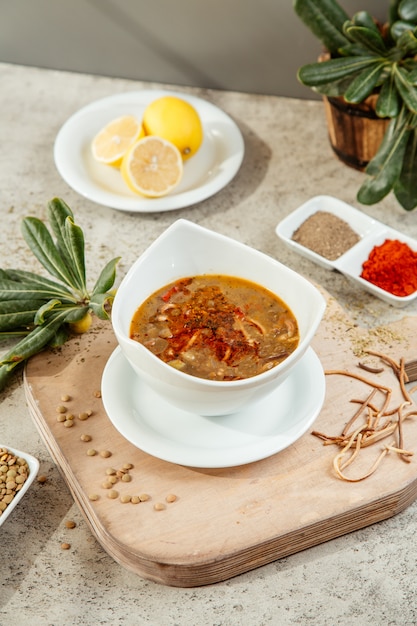 Soup served with spices and lemon