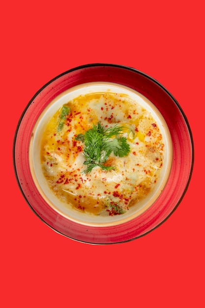 Soup topped with pepper and herbs