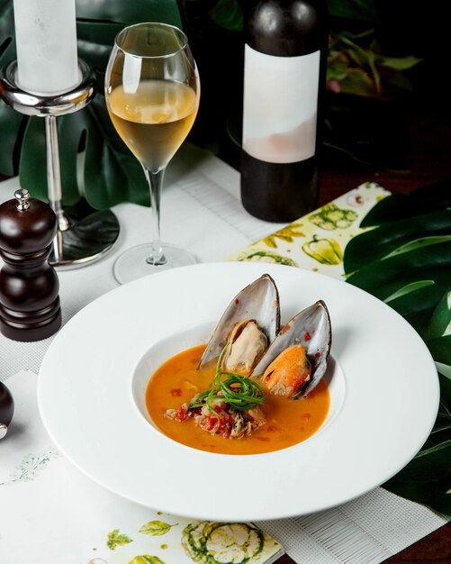 Soup with oysters with glass of wine