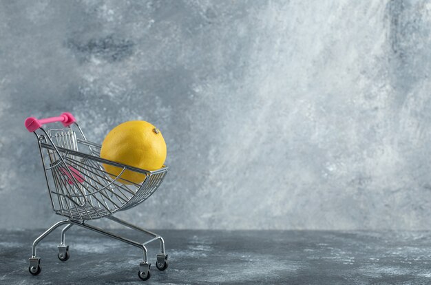 Sour lemon placed in small shopping cart