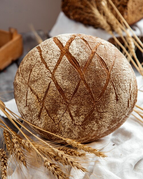 sourdough bread with wheat on table