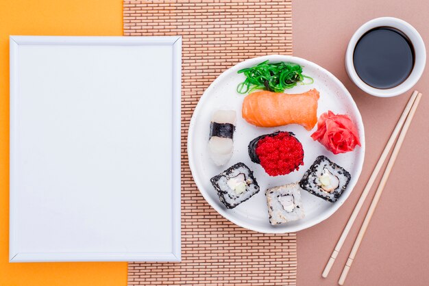 Soya souce and fresh sushi on table