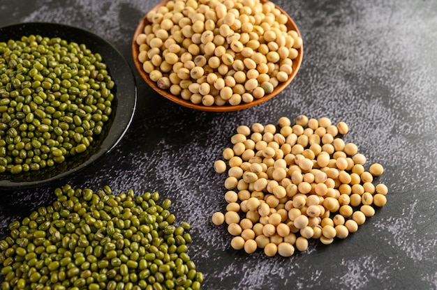 Soybean and Mung bean on a black cement floor.