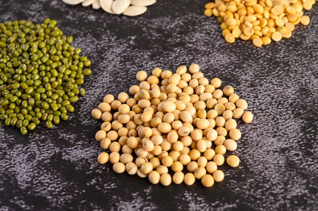 Soybean and Mung bean on a black cement floor.