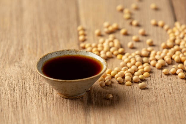 Soybean Sauce and Soybean on Wooden Floor Soy sauce Food nutrition concept.