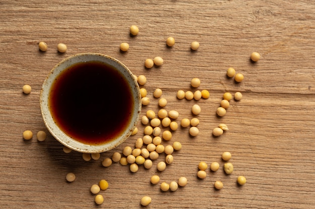 Soybean Sauce and Soybean on Wooden Floor Soy sauce Food nutrition concept.