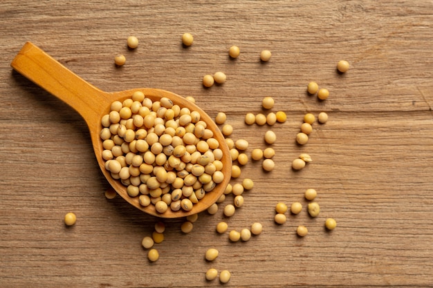 Soybean Seeds On Wooden Floor And Hemp Sacks Food Nutrition Concept.