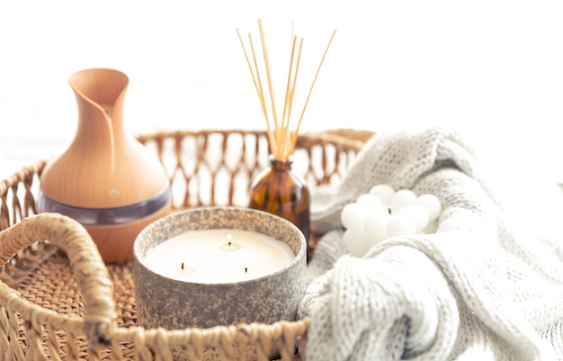 Free photo spa composition with aroma oil diffuser lamp and candle on a blurred background