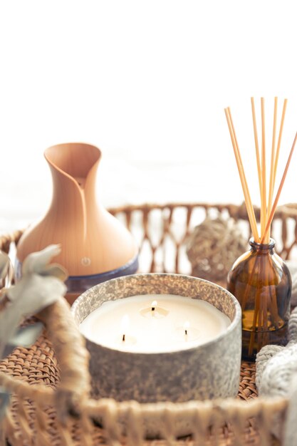 Spa composition with aroma oil diffuser lamp and candle on a blurred background