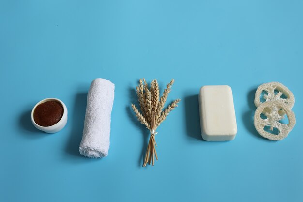 Spa composition with bath accessories on a blue background top view