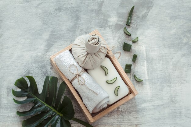 Spa composition with body care items on a light wall.