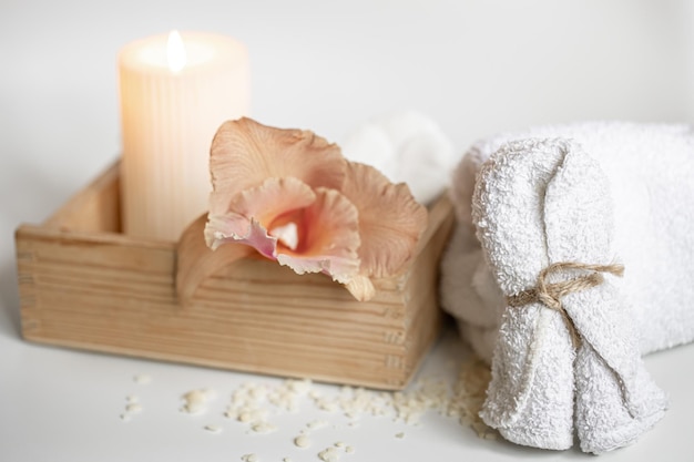 Spa composition with body care products in a wooden box and thai orchid flowers