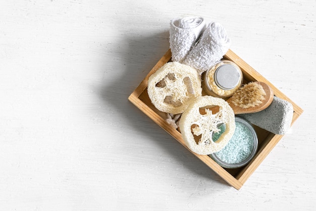 Spa composition with care products in a wooden box on white isolated