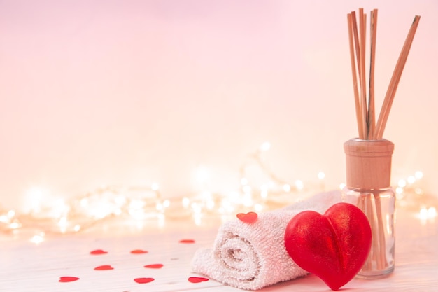 Spa composition with incense sticks towel and heart shaped soap