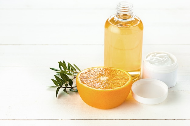 Free photo spa composition with orange, lotion and cream