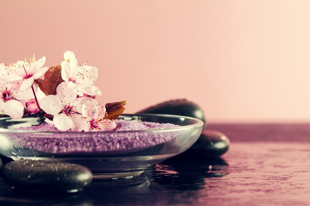 Spa Concept. Closeup of beautiful Spa Products - Spa Salt and Flowers. Horizontal.